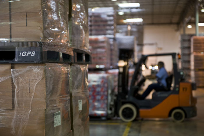 Forklift driver picking product in a warehouse