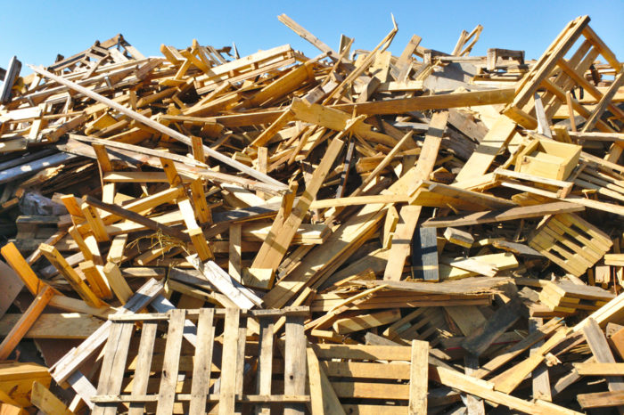 Broken wood pallets in a landfill.