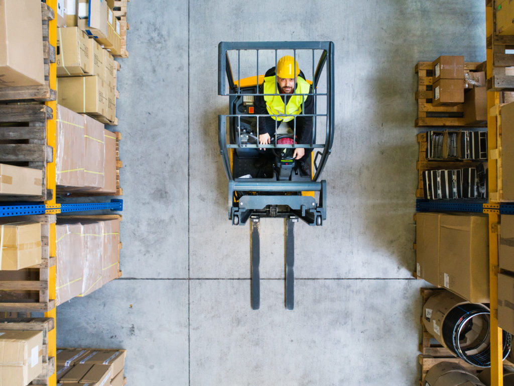 Person operating forklift in supply chain