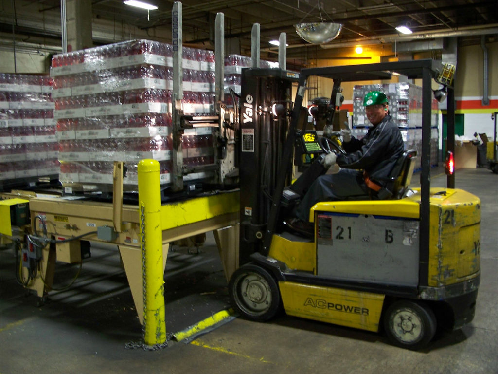 iGPS pallets loaded with grocery store goods loading onto a forklift